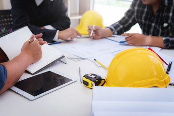 engineer people meeting working and pointing at a drawings in office for discussing. Engineering tools and construction concept.
