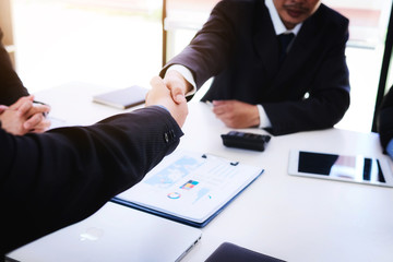 Business people shaking hands after finishing up a meeting good teamwork in office.Teamwork successful Meeting Workplace strategy Concept.