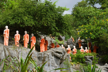 Sculptures of Buddhist monks on the territory of the Golden Temple. Dambulla, Sri Lanka