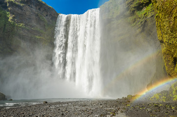 The marvelous Seljalandsfoss waterfall in Iceland with a double rainbow
