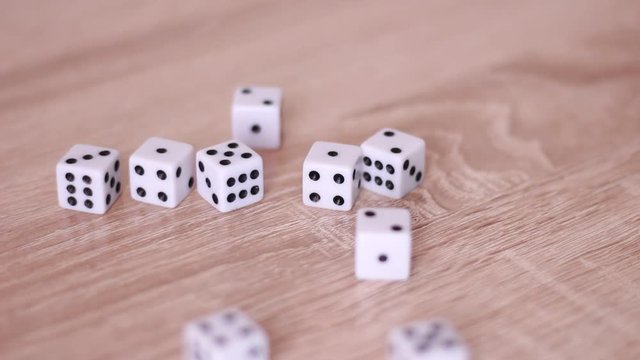 Male hand throwing dice on table