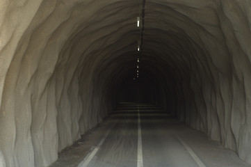 Cycling tunnel, gray concrete entrance with lights