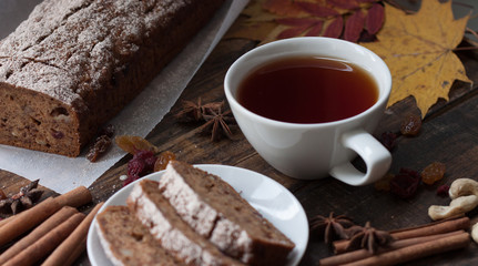 Homemade banana bread with anis star and cinnamon on a dark wooden background