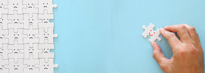 concept image of chosen person among others. a smiling face stands out from the crowd