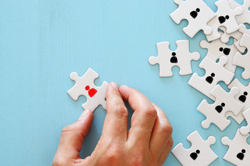 image of puzzle with people icons over wooden table ,human resources and management concept.