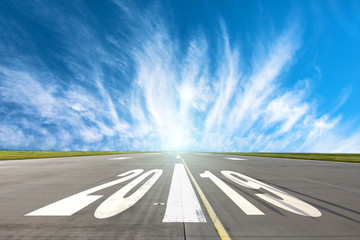 Fototapeta premium Runway asphalt road with the inscription 2019 year with a beautiful sky. The concept of the beginning of new goals and affairs.