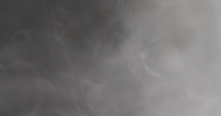 Slow motion closeup vapor floating in air on black background