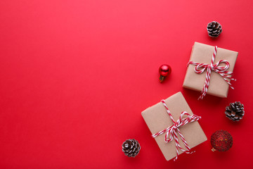 Gift presents box with christmas decor on a red background.