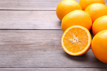 Ripe orange fruit on a grey background