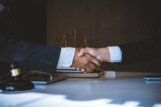 Lawyer business man shaking hands with clients, after finishing up a Consulting for insurance rent house. concept of home protection, family, insurance.