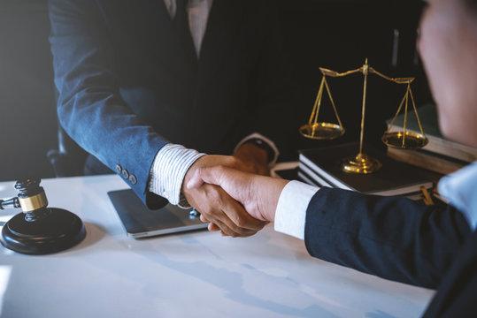 Lawyer business man shaking hands with clients, after finishing up a Consulting for insurance rent house. concept of home protection, family, insurance. - Powered by Adobe