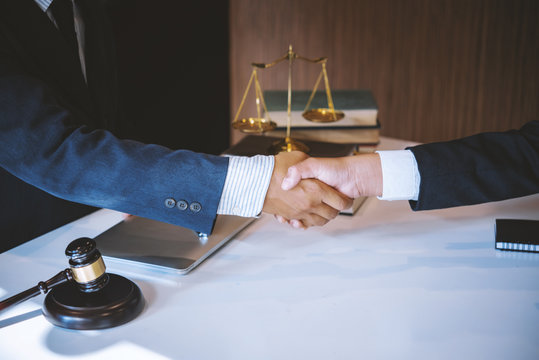 Lawyer business man shaking hands with clients, after finishing up a Consulting for insurance rent house. concept of home protection, family, insurance.