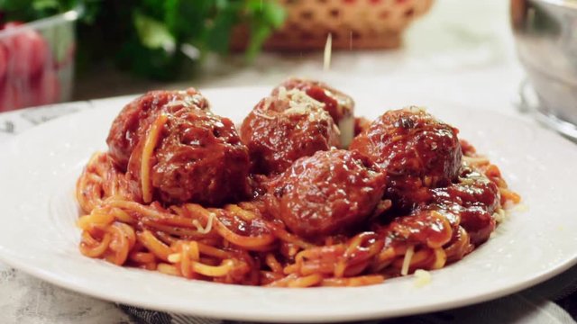 Serving spaghetti with meatballs in tomato sauce