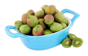 Dish filled with ripe Kiwi berries isolated on a white background