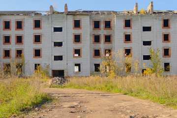 collapsing multi-storey brick residential building in the spring afternoon