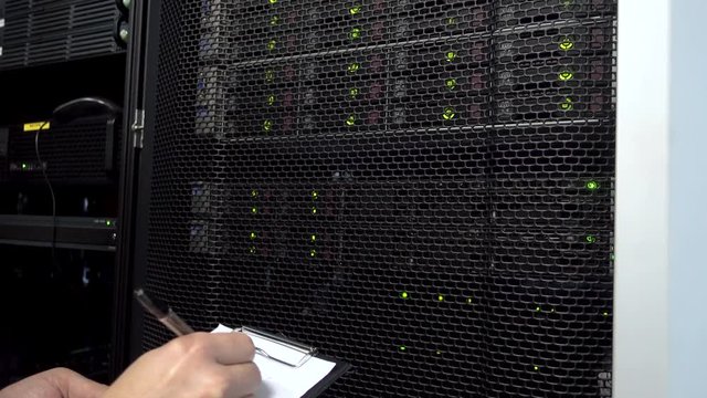 The engineer checks the system of data storage. LED indication of the data storage system.