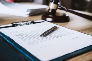 Close up of Ink pen on contact papers form. lawyer concept.