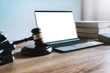 Workspace of lawyer with laptop blank white screen and law wooden gavel,legal book and brass scale of judge. lawyer and law ,judiciary and legislature courtroom legal concept. top view flatlay lawyer.