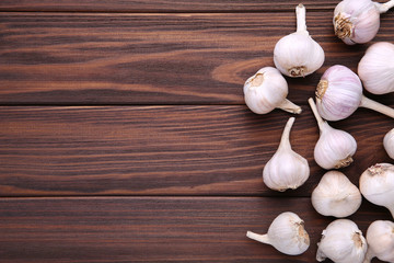 Fresh garlic on a brown wooden background