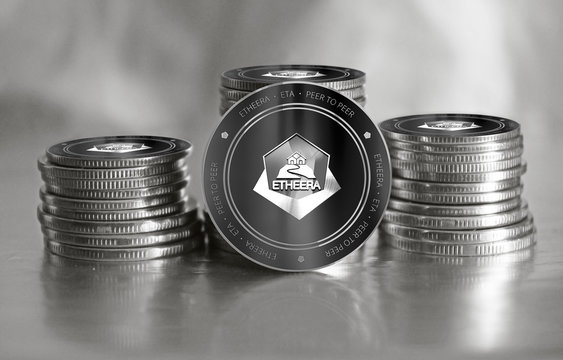 Etheera (ETA) digital crypto currency. Stack of black and silver coins. Cyber money.