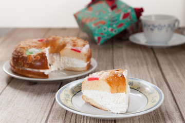 Spanish typical dessert of epiphany  cut piece on plate on wood