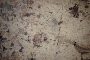 Dark brown spots on the surface of beige cardboard.