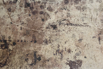 Dark brown spots on the surface of beige cardboard.