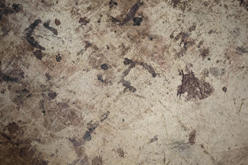 Dark brown spots on the surface of beige cardboard.