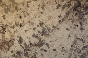 Dark brown spots on the surface of beige cardboard.
