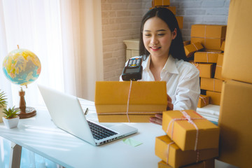 Business woman owner or freelance woman working at home with use bluetooth barcode scanner for save...