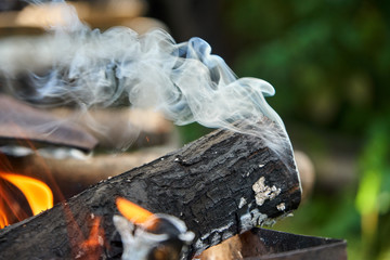 Burning logs in the grill, smoking log