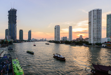 Fototapeta na wymiar Cityscape of Asiatique the Riverfront is popular and famous place in the evening with sunset time at Bangkok, Thailand.