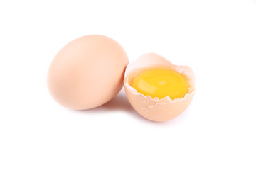 Chicken eggs and half with yolk on a white background.