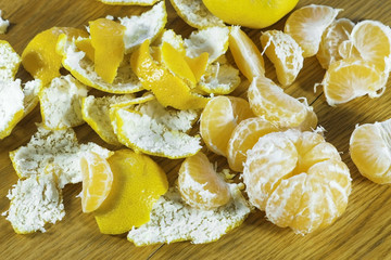Tangerines and peel on the kitchen table. Close-up view.