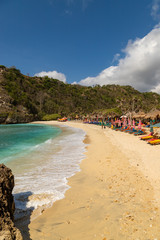 NUSA PENIDA,  INDONESIA - OCTOBER 23, 2018: Sunbeds at empty Atuh Beach on Nusa Penida in Indonesia.