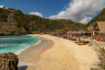 NUSA PENIDA,  INDONESIA - OCTOBER 23, 2018: Sunbeds at empty Atuh Beach on Nusa Penida in Indonesia.