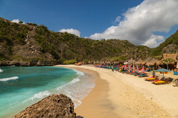 NUSA PENIDA,  INDONESIA - OCTOBER 23, 2018: Sunbeds at empty Atuh Beach on Nusa Penida in Indonesia.