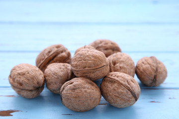 Walnuts kernels on blue wooden background. Walnut healthy food