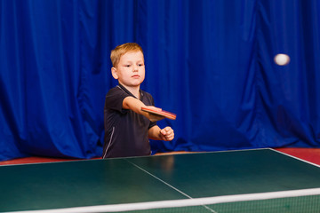 sports children's section of table tennis, boy playing table tennis