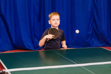 kid playing ping-pong