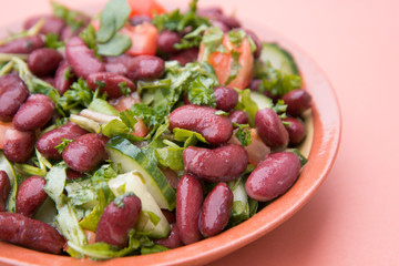 Cooked red beans plate on pink background, isolated. Healthy food.