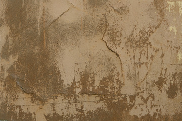 Old plaster walls with remnants of brown paint. Grunge texture.