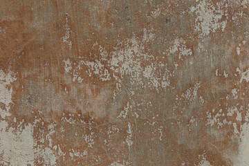Old plaster walls with remnants of brown paint. Grunge texture.