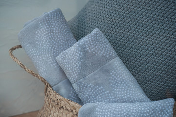 closeup of grey bath towels in basket in store showroom