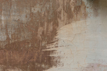 Old plaster walls with remnants of brown paint. Grunge texture.