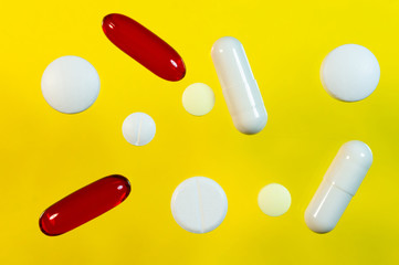 Pills on the yellow background
