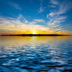 Fototapeta na wymiar dramatic sunset reflected in a water
