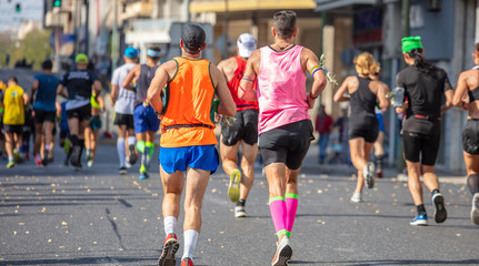 Marathon running race, runners running on city roads