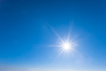 Naklejka na ściany i meble sparkle sun on a blue sky, natural background