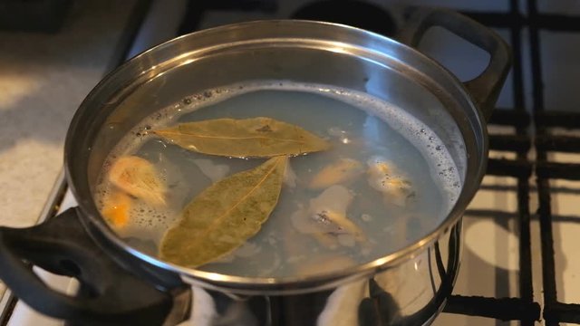 Mussels and shrimps are boiled in boiling water in a saucepan.